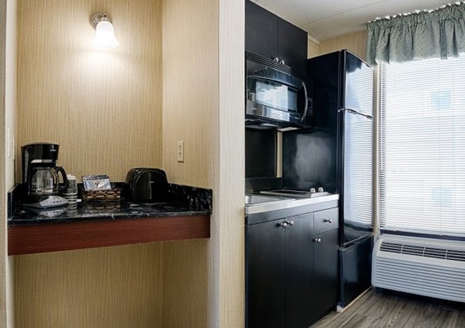 Kitchenette at the Barefoot Mailman with a coffee maker, microwave, cabinets and fridge.