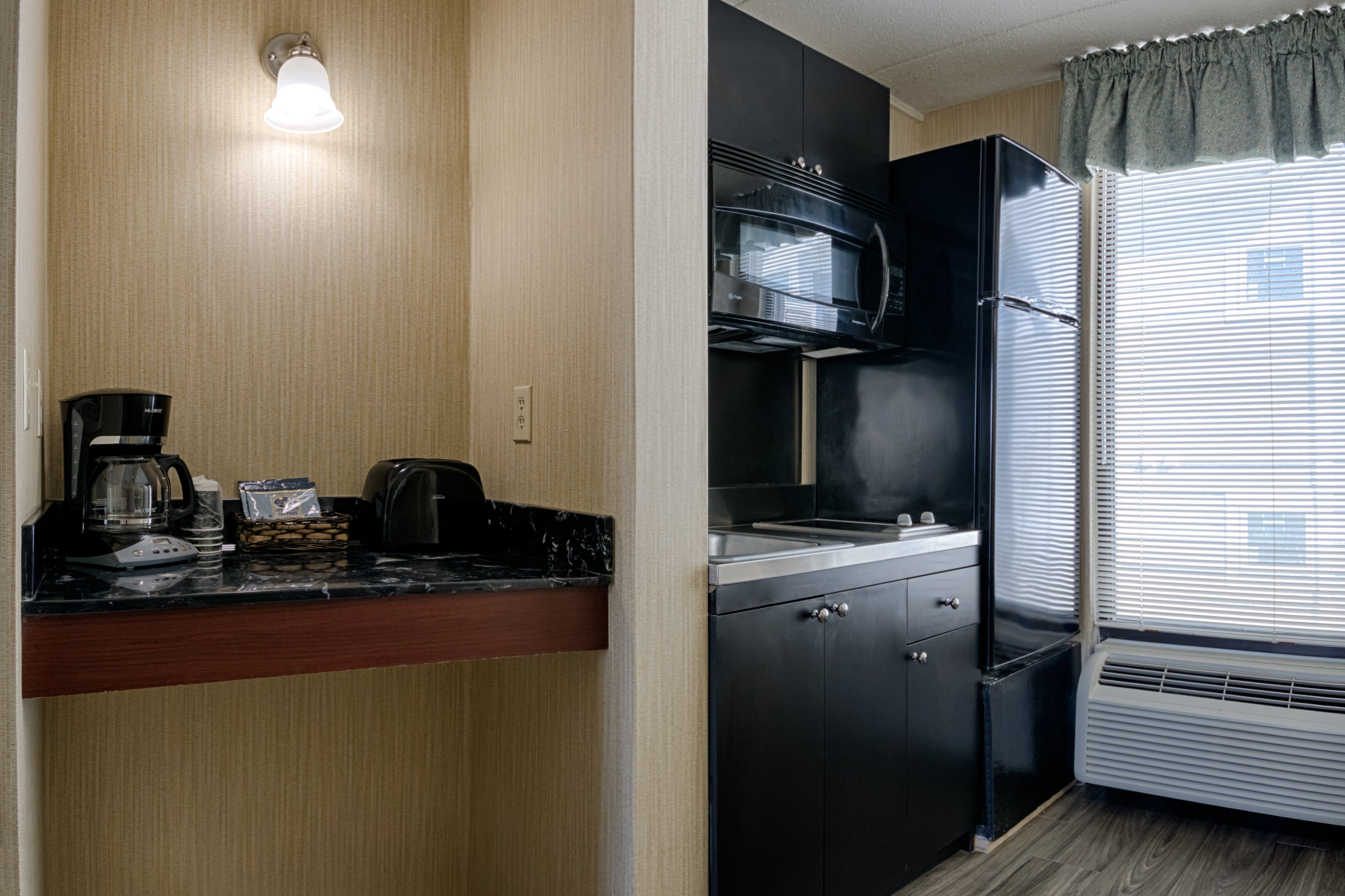 A coffee maker, microwave, cabinets and fridge in the Barefoot Mailman rooms.